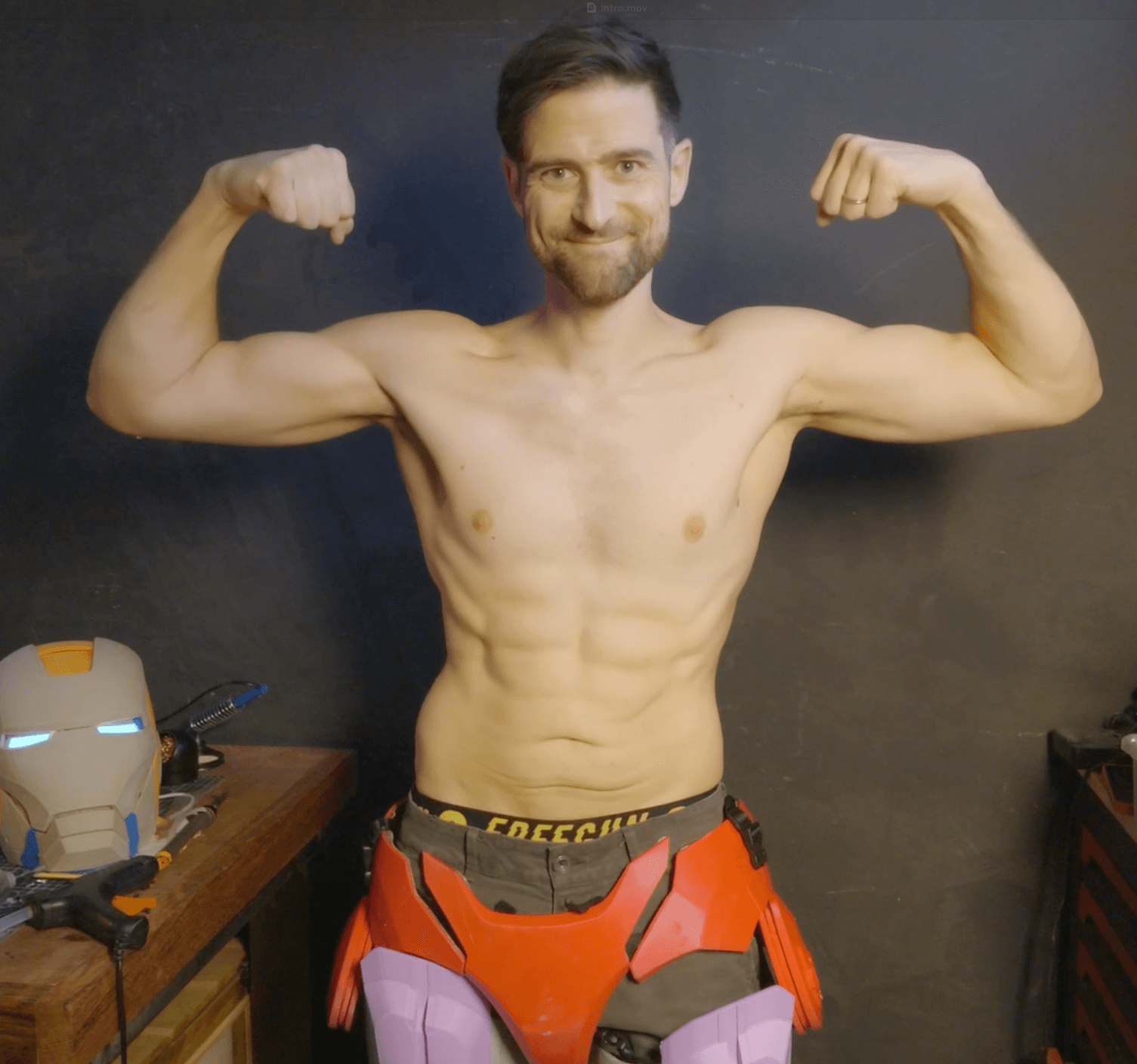 Tibo after the challenge: 160 lbs, flexing in the workshop with the suit legs on